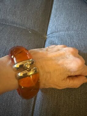 Hinged Studded Resin Bangle Bracelet Featuring a Translucent Amber Color.